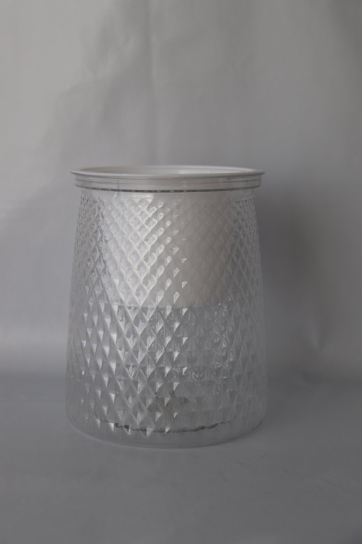 Clear plastic self-watering planter with water reservoir for easy care