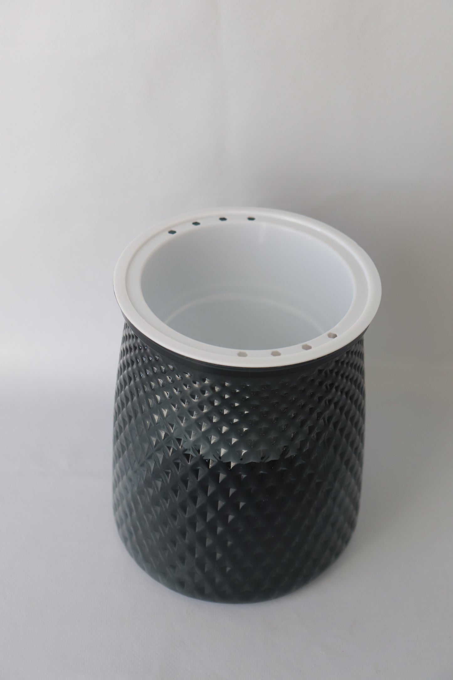 Grey plastic self-watering planter with water reservoir for easy care