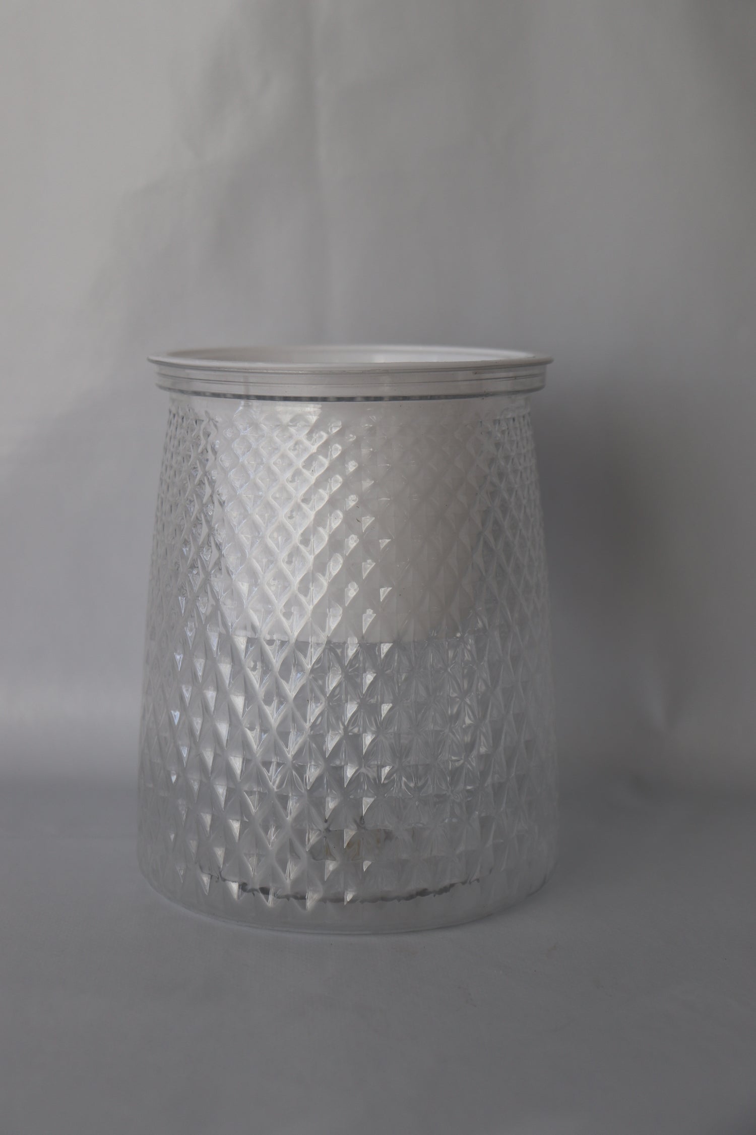 Clear plastic self-watering planter with water reservoir for easy care