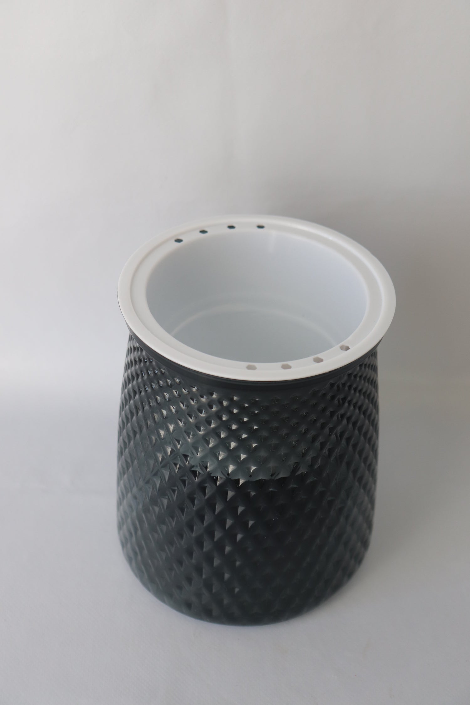 Grey plastic self-watering planter with water reservoir for easy care