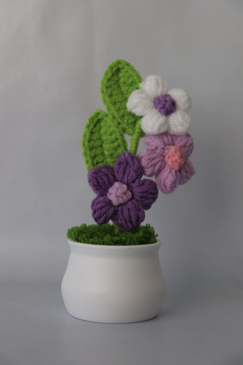 Crocheted flowers and leaves on a white background